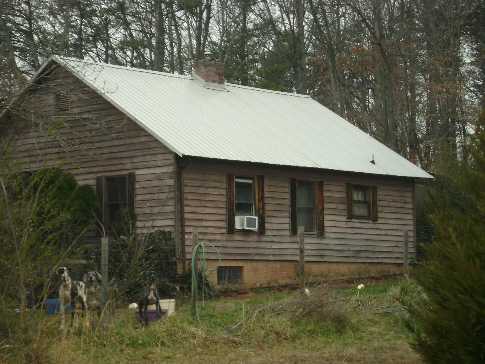 White metal roof on an old wood sided farmhouse, from a Metal Roof Installation job in Logandale